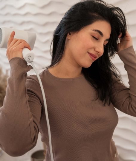 women hand on hair dryer - Hair Care